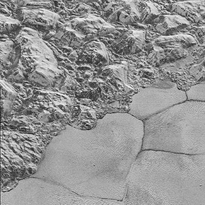 Mountains of ice along a portion of smoother ice planes on Pluto's surface.